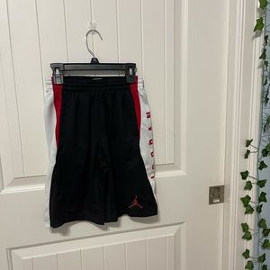 Black, white, and red Nike basketball shorts
